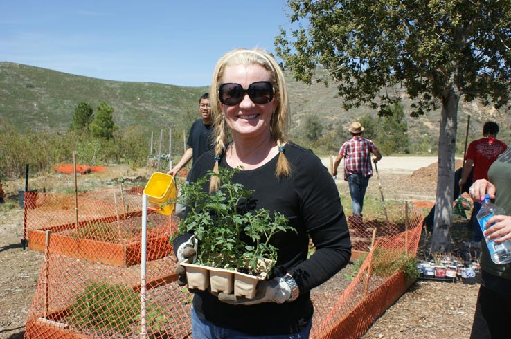 Woman holding a tray of plants